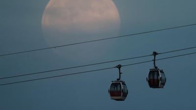 A full pink supermoon rises above the Emirates Air Line cable car in London, Britain. Reuters