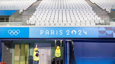 Workers prepare the venue of the Olympic Aquatics Centre ahead of the Paris 2024 Olympic Games on July 16