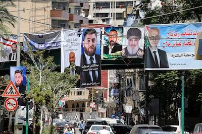 Electoral banners of Lebanese candidates running in the country's municipal election and a picture of slain Hezbollah leader Hassan Nasrallah (2-R) hang from a bridge above the traffic in Beirut, Lebanon, on May 16. EPA